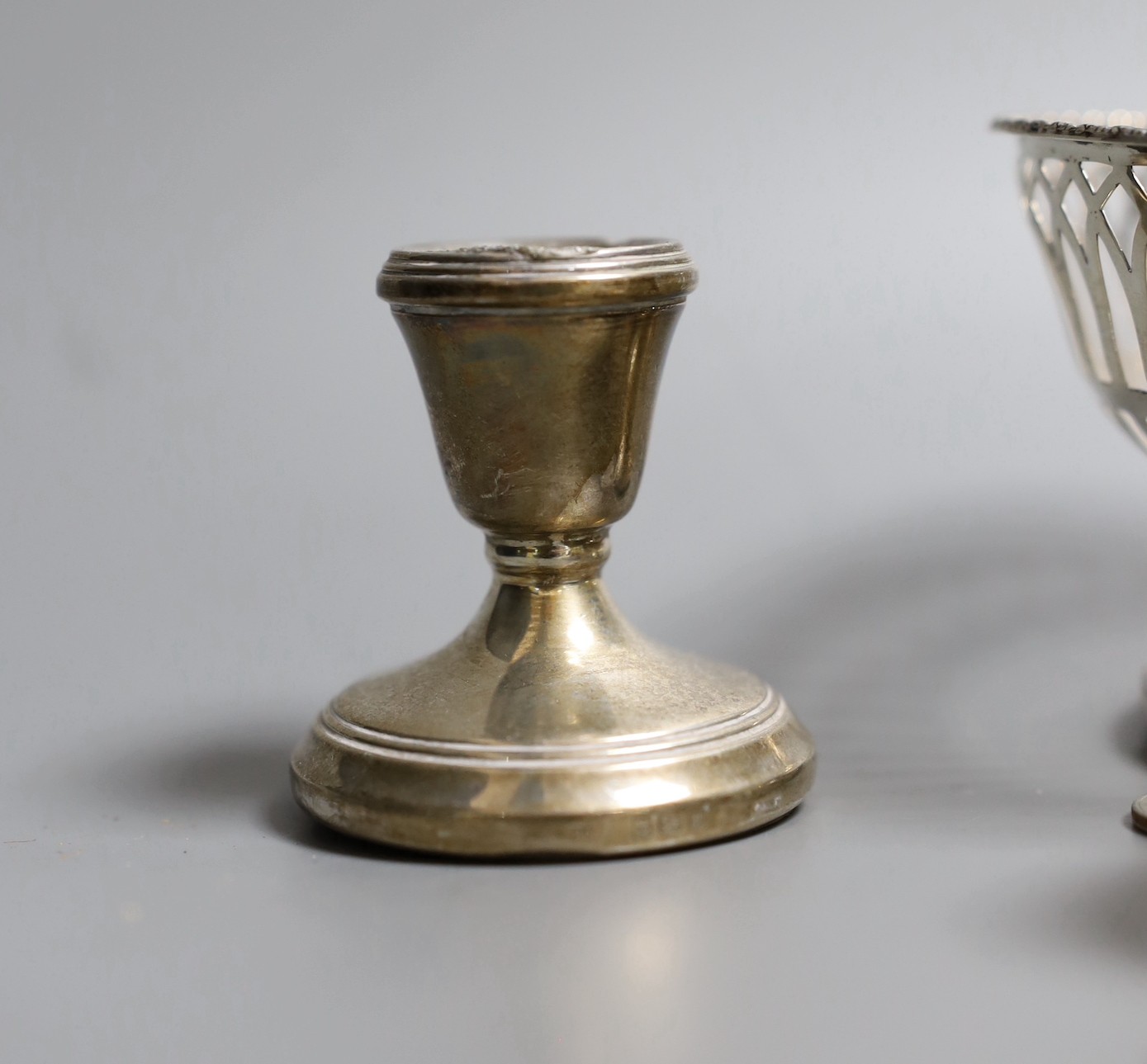 Mixed silver items including a pair of George V pierced silver bowls, weighted, a pair of pierced silver shell dishes, a pair of dwarf candlesticks, a silver napkin ring and other items including compact and assorted coi